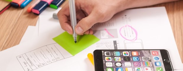 Stock image of a website designer sketching mobile app designs